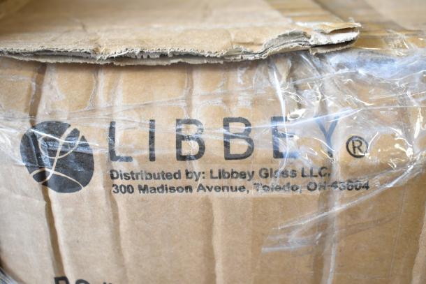 Cardboard box showing Libbey branding, partially wrapped in plastic. Packaging appears slightly damaged.