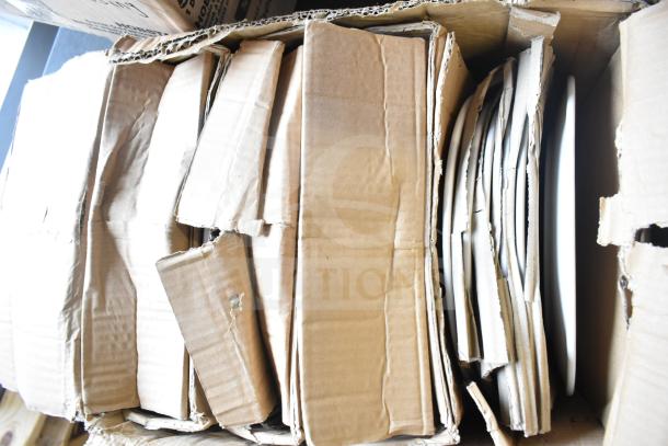 Cardboard boxes containing new Libbey 10 3/8" porcelain plates. Boxes show slight wear; plates appear intact.