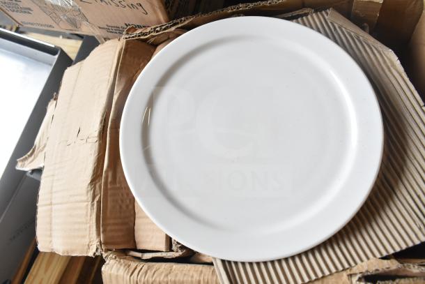Brand new Libbey 840-440N-15 Porcelana 10 3/8" round bright white narrow rim porcelain plate, shown partially in its packaging.