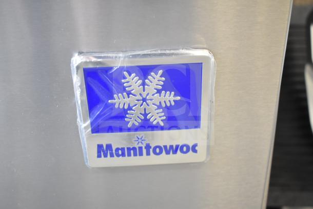 New 2026 Manitowoc IYP0600A-161 ice machine, 672 lb capacity, 115V, 1 phase, with visible logo sticker on stainless surface.