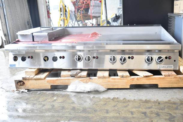 Brand new Garland GTGG60-GT60M 60" propane griddle, 140,000 BTU, thermostatic controls, minor scratches, on pallet.