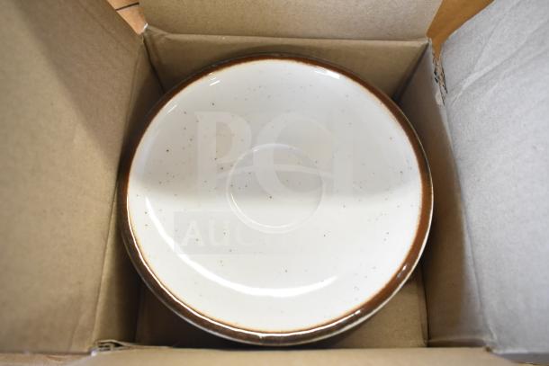 Acopa Keystone 6.5" Vanilla Bean Porcelain Saucer in box, new condition, features speckled design and brown rim.