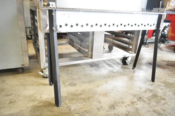 BRAND NEW Scratch and Dent Backyard Pro KEBAB-46, 45 3/8" stainless steel charcoal kebab grill with visible wheel casters.
