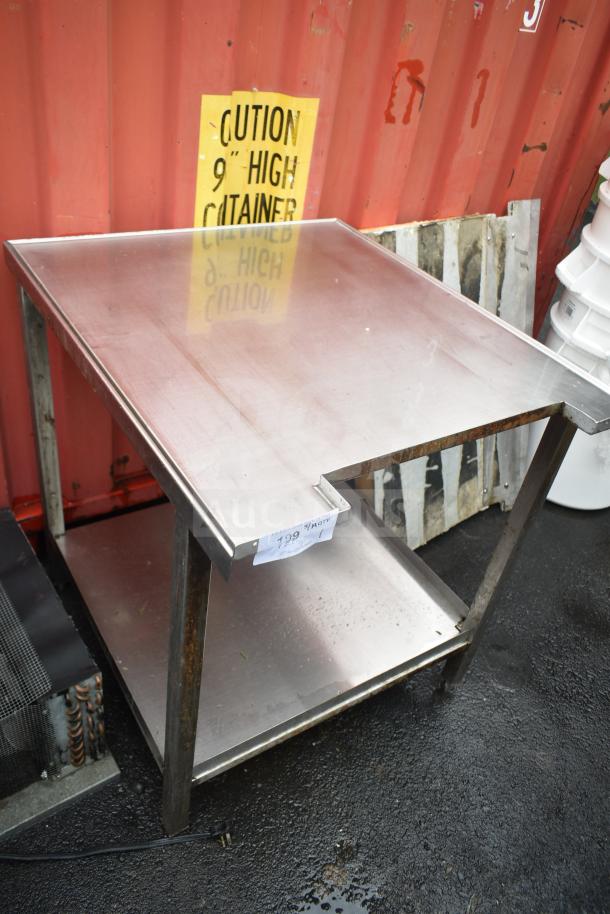 Stainless steel commercial table with under shelf, visible wear, and price tag reading "799." Ideal for restaurant use.