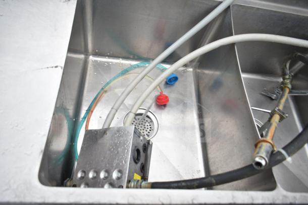 Commercial 3 Bay Sink with dual drain boards, includes visible hoses and fittings. Ideal for restaurant use. Good condition.