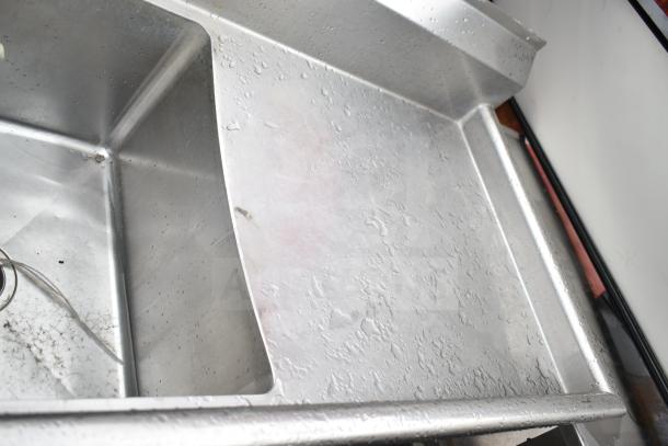 Commercial 3 Bay Sink with dual drain boards, stainless steel, visible water spots, good condition, ideal for restaurant use.