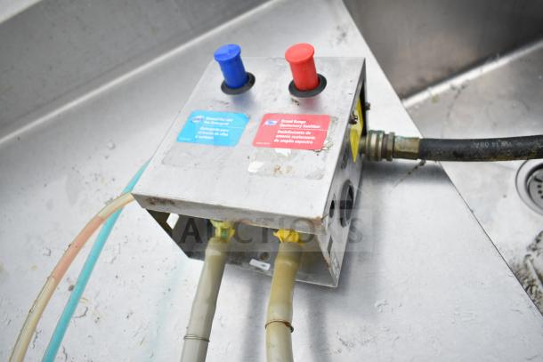 Commercial 3 bay sink with dual drain boards. Features labeled detergent and sanitizer mixer box, slightly worn condition.