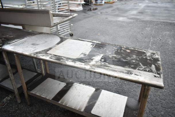 Commercial stainless steel table with under shelf, shows signs of wear. Ideal for kitchen or industrial use.