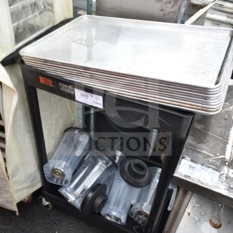 Black two-tier poly cart holding baking pans and blender pitchers. Visible labels suggest contents included. Good condition.