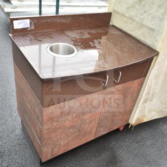 Brown counter with trash deposit hole, featuring two doors and metal handles. Ideal for efficient waste management.