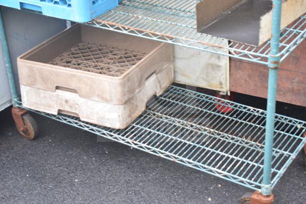Green 4-tier wire shelving unit on commercial casters, includes contents, buyer must dismantle, freight suggested.