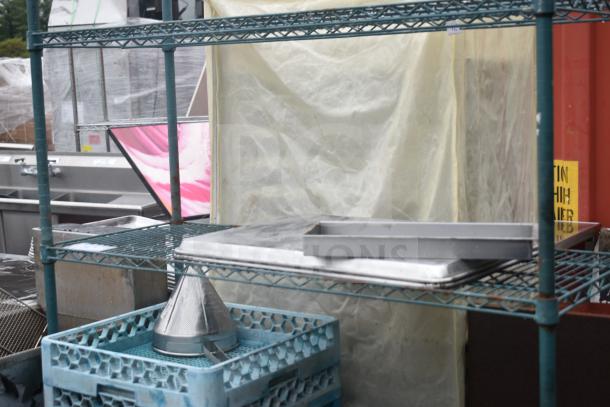 Green finish 4-tier wire shelving unit on commercial casters with contents, including metal trays and equipment. Buyer to dismantle.