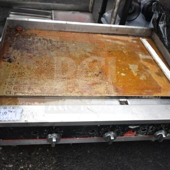 Vollrath Cayenne commercial gas griddle with thermostatic controls, visibly worn surface, model tag shown.