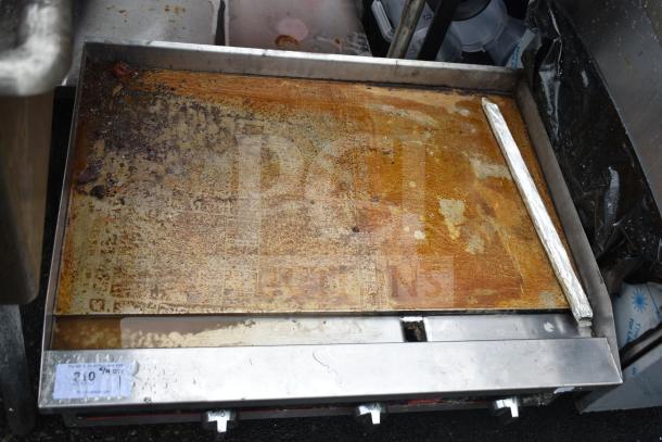 Vollrath Cayenne gas-powered flat top griddle, used condition, with thermostatic controls and visible surface wear.