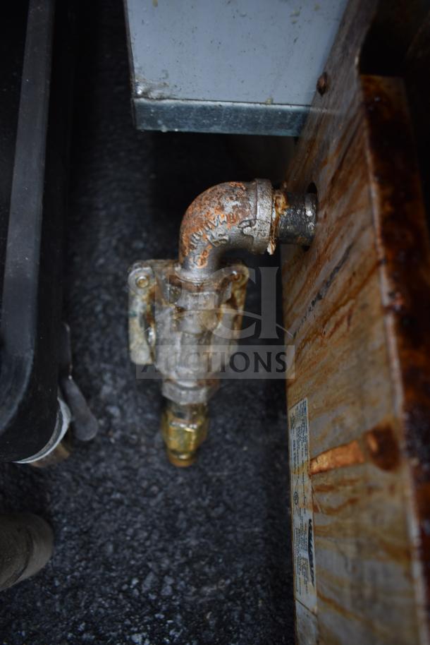 Vollrath Cayenne Commercial Griddle gas connection, showing rust and a label with specifications.