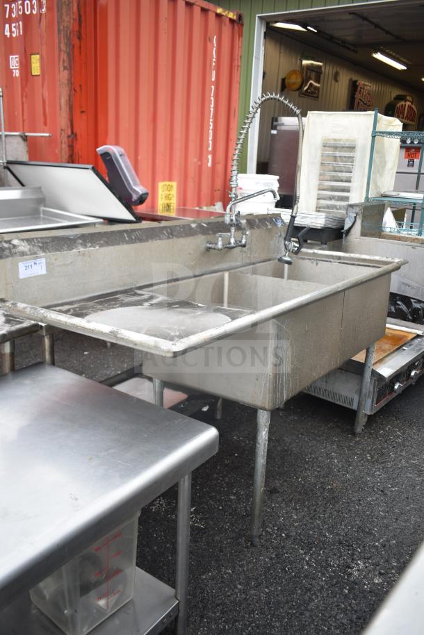 Commercial 2-bay sink with left-side drain board, durable metal finish, integrated sprayer, and faucet. Good condition.