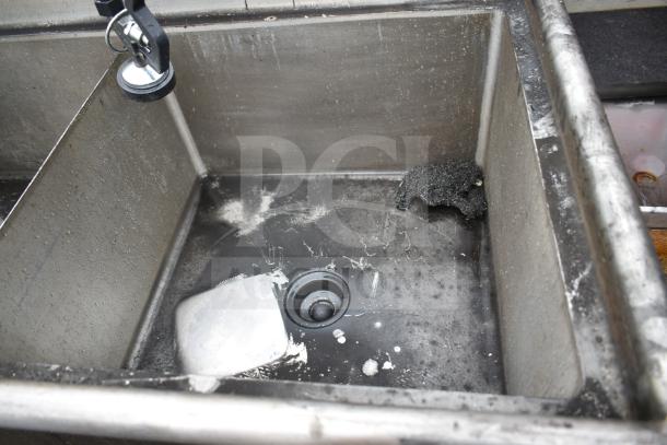 Commercial 2 Bay Sink with left side drain board, stainless steel, used condition, visible grime, dual compartments.