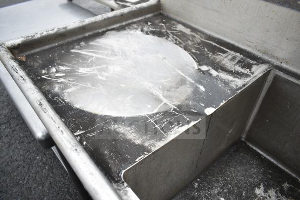 Commercial 2 bay sink with left side drain board, visible wear and scratches, stainless steel construction, auction item.