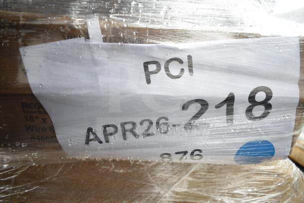 Plastic-wrapped auction lot labeled "APR26-218," includes shelves, bar stool, speed rail. Scratch and dent condition.