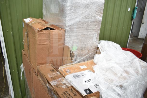 Packaging of seven brand new items, including a dish table and sneeze guard, wrapped in plastic with visible tape and labels.
