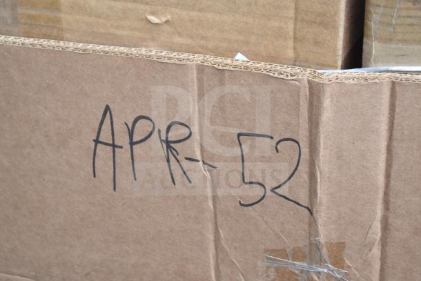 Brown cardboard box with handwritten "APR-52", containing 7 brand new scratch and dent items, including a dish table and sneeze guard.