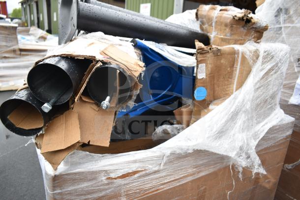 11 scratch and dent items in box, including table base pieces and a blue chair. Items wrapped in plastic with visible cardboard.