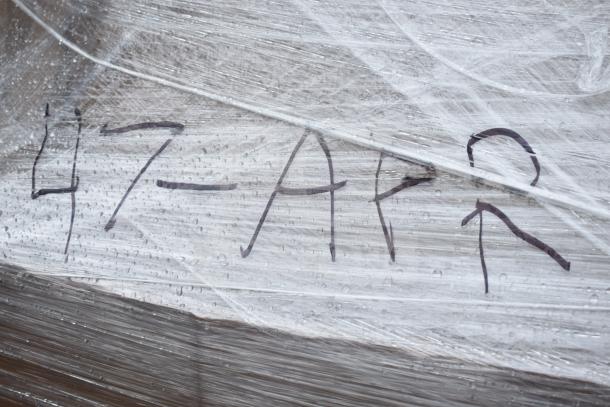 Plastic-wrapped pallet marked "47-APR" containing 11 new scratch and dent items, including table bases and a blue chair.