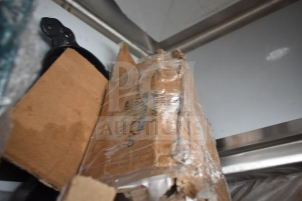 Cardboard box with visible scratch and dent damage; contains new items including a sink and ice bin. Packaging shows wear.