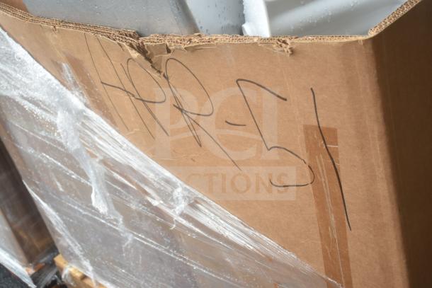 Cardboard box marked "APR-51" containing brand new scratch and dent items, including a sink and shelves.