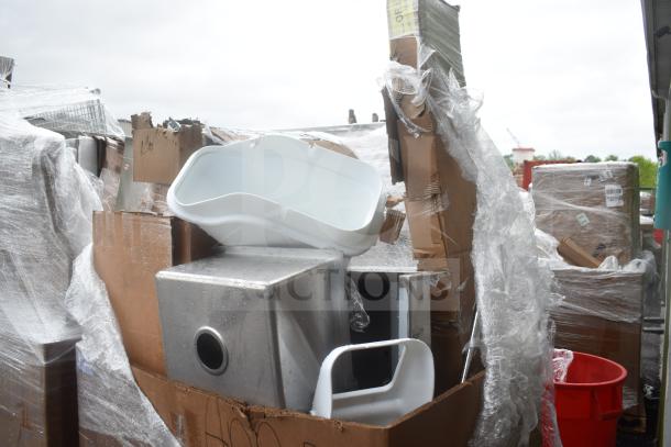 Nine new scratch and dent items including a white sink and metal shelving, wrapped in plastic, showing slight damage.