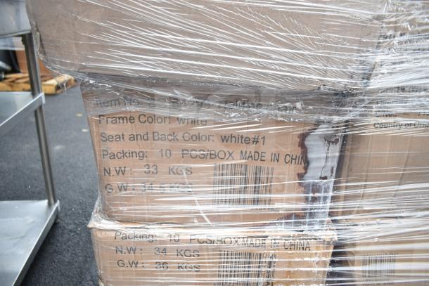 Plastic-wrapped pallet of boxed folding chairs, white frame and seat, label indicates 10 chairs per box, scratch and dent condition.