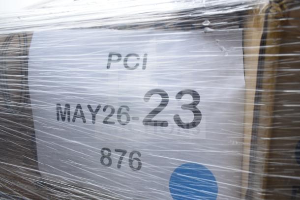 Plastic-wrapped pallet labeled "PCI MAY26-23" containing 26 scratch and dent items, including napkins, cold cups, and containers.
