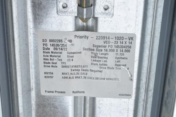 Label on metal component detailing specs for a VCD-23 14 x 14, including blade material, axle, and seal type.