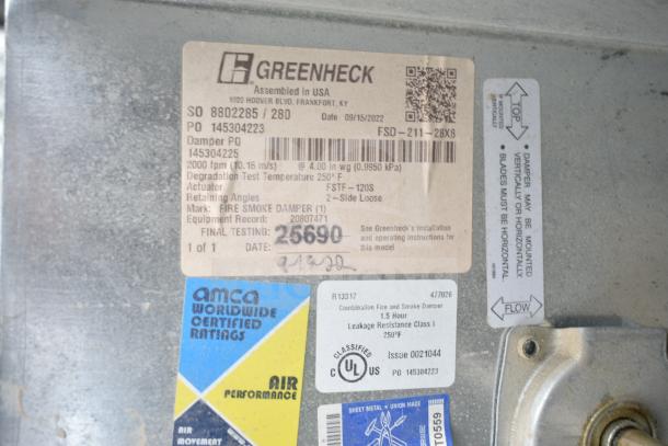 Greenheck fire smoke damper, label details model FSD-211-28X8, AMCA certified, UL classified, assembled in USA.
