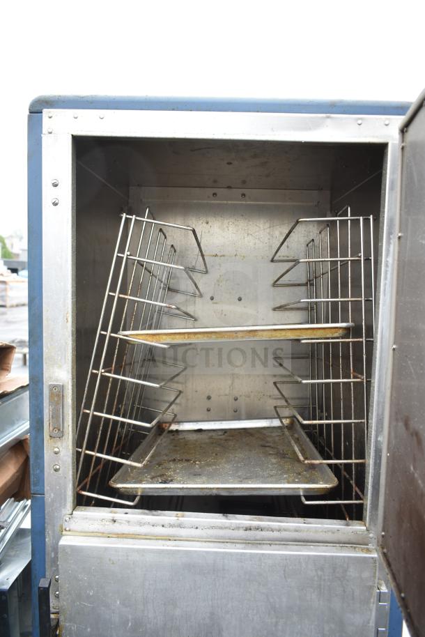 Metro C539-HDS-4-BU commercial heated holding cabinet with racks, on commercial casters, 120 volts, 1 phase, open door view.