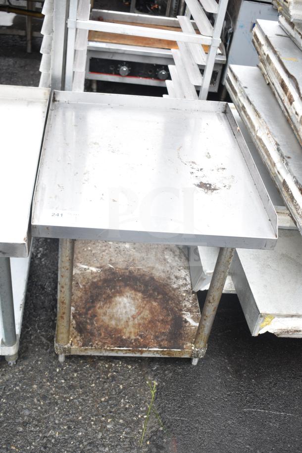 Commercial equipment stand with under shelf, metallic finish, used condition, visible rust and wear.