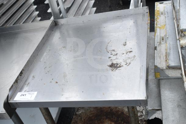 Commercial equipment stand with under shelf, stainless steel, surface wear evident, auction tag "241" visible.