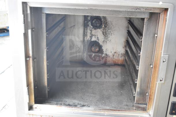 Nu Vu PMA-5/18 commercial electric oven, 208V, 3-phase, missing glass. Interior shows wear and use.