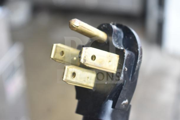 Close-up of a plug from a Nu Vu PMA-5/18 commercial electric oven. Oven missing glass, 208 volts, 3 phase.