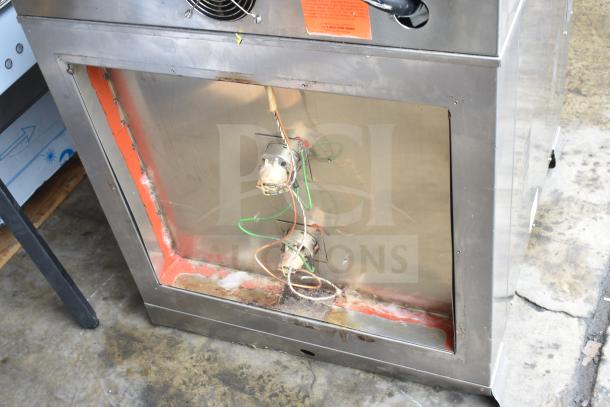 Nu Vu PMA-5/18 commercial electric oven, 208 volts, 3 phase, missing glass, visible wiring and structure, stainless steel exterior.