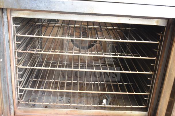 Vulcan commercial full-size convection oven with view-through doors, thermostatic controls, metal racks, and visible wear.