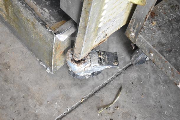 2020 Henny Penny PFG-691 fryer caster detail on commercial floor, showing wear and rust.