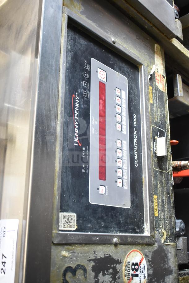 Henny Penny PFG-691 Computron 8000 pressure fryer, natural gas, 100,000 BTU, on commercial casters, worn exterior, control panel visible.