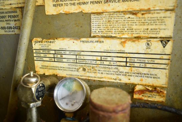 Henny Penny PFG-691 pressure fryer with Computron 8000, 100,000 BTU, natural gas, on commercial casters. Visible labels indicate specifications.
