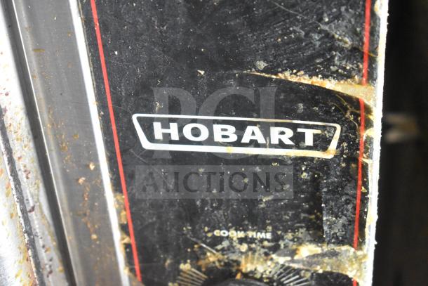 Hobart commercial convection oven label, visible wear, featuring view-through doors, thermostatic controls, on metal legs.