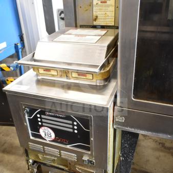 2020 Henny Penny PXE-100 electric pressure fryer on casters, 208V, 3 phase; shows usage wear, label with operating instructions.