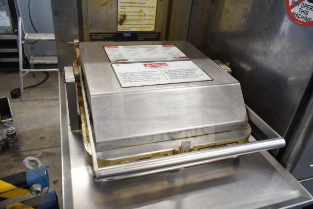 2020 Henny Penny PXE-100 electric pressure fryer on casters, 208V, 3-phase; includes safety warning labels and durable design.