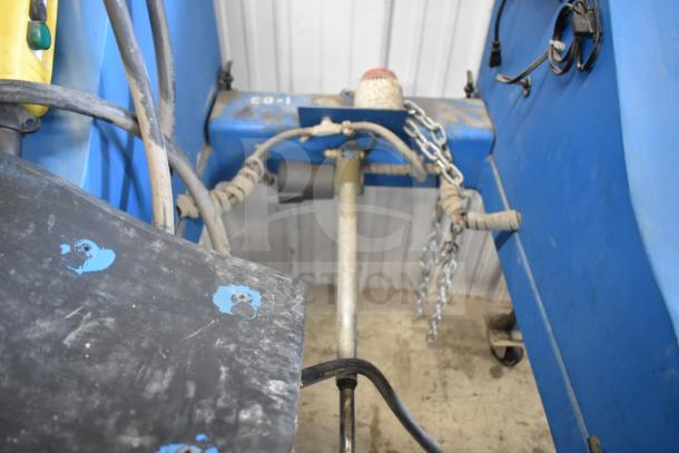 Vac Lift AS Commercial Unit in used condition. Features hydraulic hoses, metal frame, and control box. Visible chains and panel.
