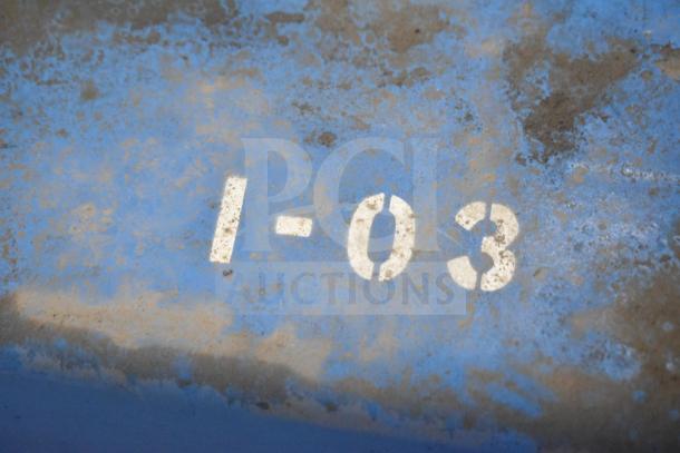 Vac Lift AS Commercial Unit with visible markings "I-03," showing signs of wear, blue surface finish.