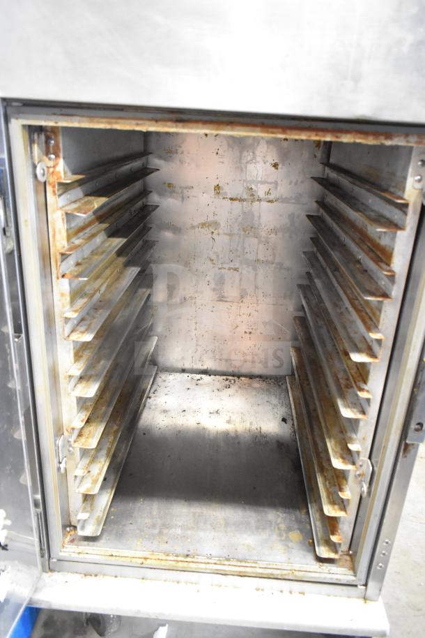 Henny Penny HC-900 CDT heated holding cabinet, stainless interior, visible wear, multiple shelf slots.